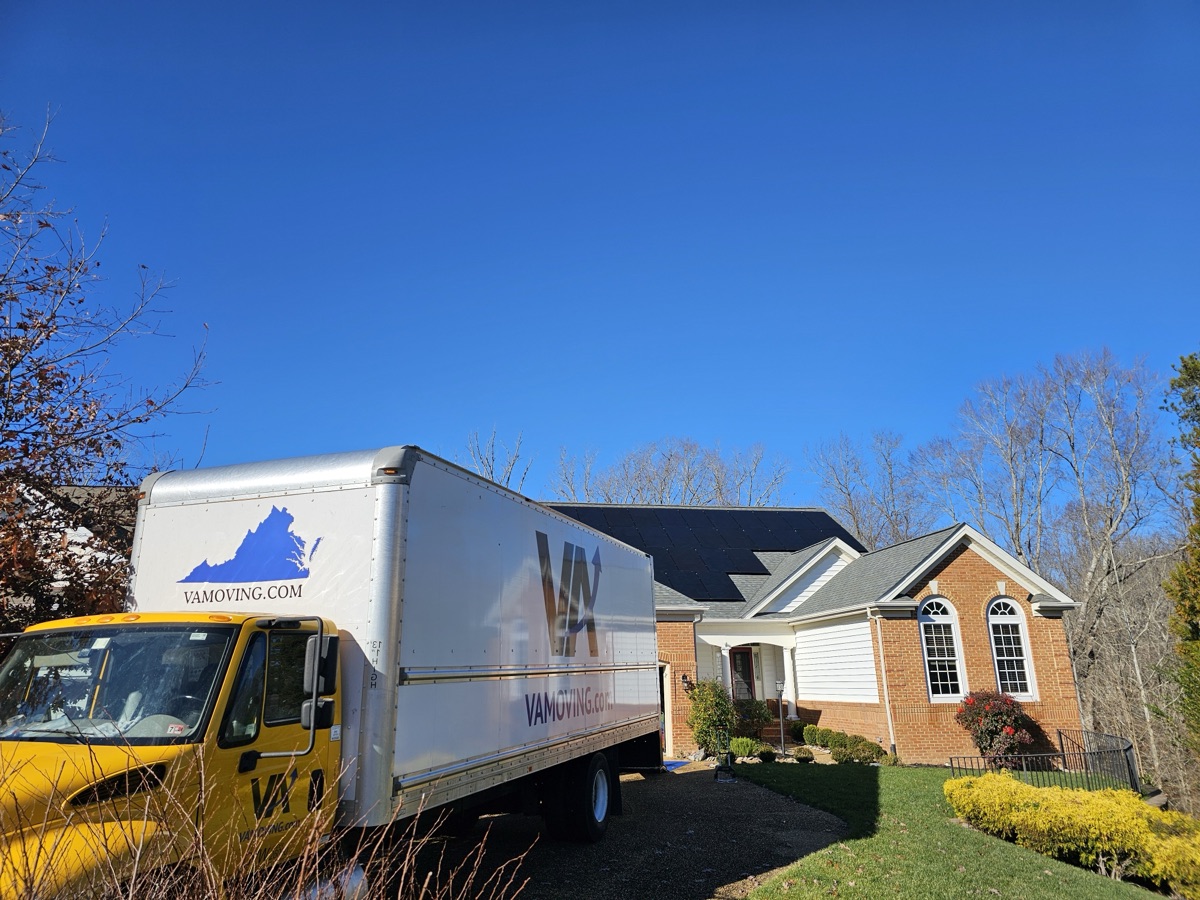 Large moving truck in front of a house